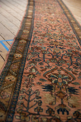 Lengthwise perspective of a vintage Lilihan runner with an allover floral design on a rose field.