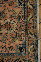 Delicately contoured floral buds on a Lilihan rug in dusty rose, bronze, and sky blue.