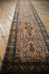 Angled view of the long vintage Lilihan runner, highlighting its allover floral pattern on a dusty rose field.