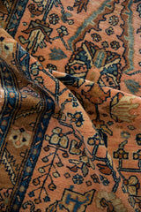 A draped view highlighting the even pile and detailed vinery of a vintage Lilihan rug.