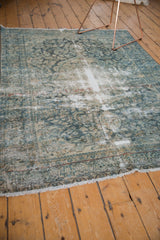 Worn ivory fringe and intact side selvage on a distressed vintage Lilihan rug.