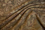 Textural wear on a draped vintage Malayer carpet with olive green and raspberry scrolling vines.