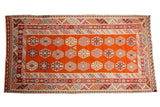 Vintage Turkish Kilim rug, tangerine orange field with triple column geometric gul motifs.