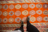 Bright tangerine orange vintage Turkish Kilim with repeating geometric gul motifs.