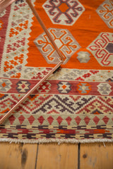 Vintage Turkish Kilim detail: geometric gul motifs in tangerine, ivory, and raspberry tones.