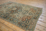 Distressed antique Farahan Sarouk rug's dramatic corner spandrel in dusty teal and terracotta.