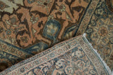 Distressed pile of the antique Farahan Sarouk rug with faint foundation showing, revealing hand-knotted reverse.