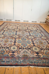 Bibikabad rug border close-up: intricate floral quatrefoils in navy, madder red, sky blue, and fringe.