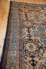 Vintage Bibikabad carpet detail: intricate floral border, navy field, and restored side selvage.