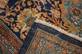 Folded vintage Bibikabad rug corner, navy field, splayed floral motifs, detailed borders, white fringe.