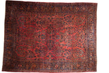 Vintage Sarouk carpet, dusty raspberry red field, dense navy floral pattern, shadow medallion.