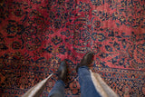 Vintage Sarouk rug, dusty raspberry red field, dense navy floral bouquets, and main border.