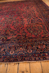Late Mohajeran Sarouk rug's dusty raspberry field, navy border details, and fringe.