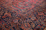 Hand-knotted Persian Sarouk corner, dense floral patterns in dusty raspberry red and navy blue.