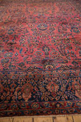 Hand-knotted vintage Sarouk border with dense navy and dusty red florals.