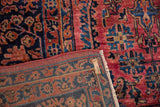 Vintage Sarouk hand-knotted pile, showing dusty raspberry florals, navy blue reverse, and tag.