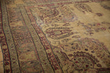 Antique Kermanshah carpet with cochineal red paisley border and light sand field abrashes.