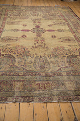 Antique Kermanshah rug's central roundel medallion, opposing inscription, and cypress motifs.