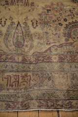 Antique Kermanshah carpet detail: cochineal red literary inscription on muted ivory field.