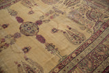 Antique Kermanshah carpet border, cochineal red paisley, beige field, with visible abrashes.