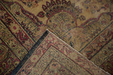 Antique Kermanshah carpet fold, revealing worn red, navy pattern, fringe, and blue selvage.