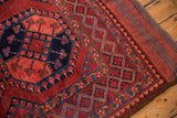 Vintage Ersari carpet corner showing red and navy geometric border and intact selvedge.
