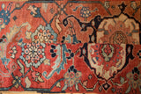Antique Serapi runner's expertly concealed seam, joining brilliant cherry red and blue floral motifs.
