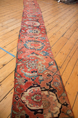 Cherry red Serapi runner with sapphire blue palmettes and scrolling floral motifs. Visible wear.