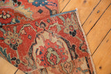 Antique Serapi rug: cherry red field, sapphire palmettes, and worn knot heads.