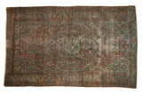 Distressed Malayer rug with faded central medallion, dusty brick red and pale denim blue.