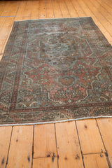 Distressed Malayer rug, highlighting worn pile, muted brick red, and pale denim blue motifs.