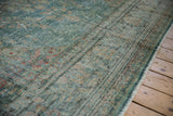 Vintage distressed Malayer carpet with even wear, faded tones, and side selvage.