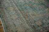 Detail of distressed Malayer carpet showing faint foundation through even wear and muted patterns.