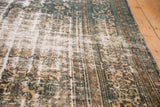 Distressed vintage Bibikabad carpet's worn texture revealing light foundation and muted Herati pattern.