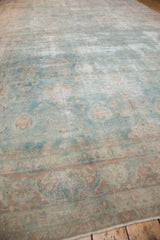 Faded powder blue field with cochineal floral motifs and wear on a vintage Yazd rug.