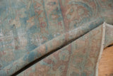 Folded vintage Yazd carpet pile with mostly even wear, faded powder blue and raspberry floral designs.