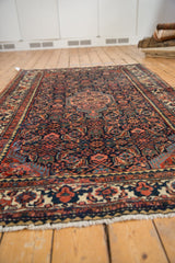 Vintage Tajabad rug fringe with madder root red pomegranate border and short pile.