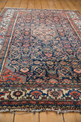 Vintage Tajabad rug end with secured ivory fringe and a red, blue pomegranate border.