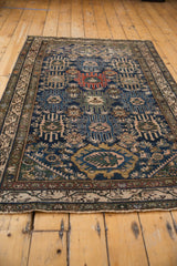Vintage Malayer rug's secured fringe and meandering vine main border in antique ivory.