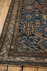 Worn fringe and intricate antique ivory border of a Persian Malayer rug.