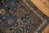 Malayer rug's antique ivory meandering vine border and navy blue field with palmettes.