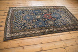 Intact side selvage on a vintage Malayer rug with meandering vine border and navy field.