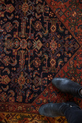 Detailed view of the Herati pattern on navy field with deep blush and gold floral border.