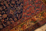 Vintage Malayer rug's navy Herati motif field contrasting with its deep gold floral border.