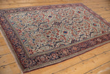 Corner view of an antique Farahan Sarouk rug, highlighting its intricate borders and restored selvage.
