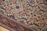 Navy and madder red geometric border of the antique Farahan Sarouk rug, with secure selvage.