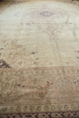 Distressed vintage Sivas carpet showing faded ivory, pale rose floral motifs and visible knot heads.