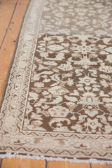 Distressed Hamadan runner corner showing intricate floral vinery in browns, ivory, and soft blue tones.