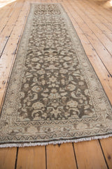 Vintage distressed Hamadan runner end, with worn pile, faded design, and light ivory fringe.