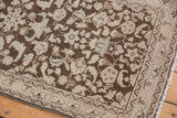 Distressed Hamadan runner corner showing detailed floral border, fringe, and time-softened palette.